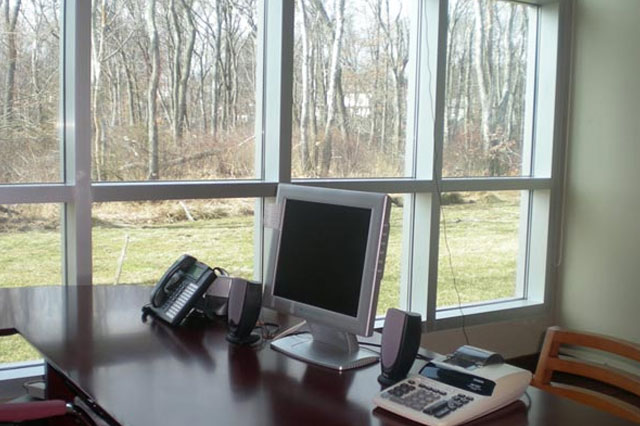 a computer and phone sitting on an office desk