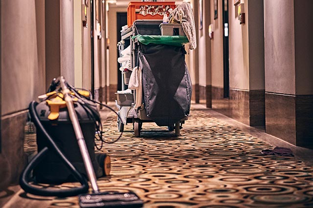 a woman holding a cardboard moving box